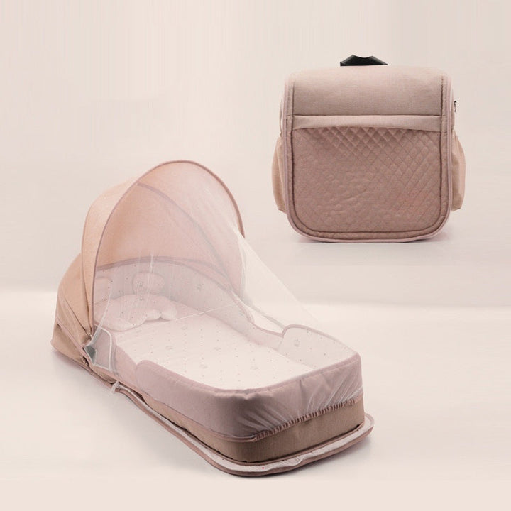 Sea Dragon Dreams portable baby lounger in beige with a protective mosquito net canopy and foldable travel design.