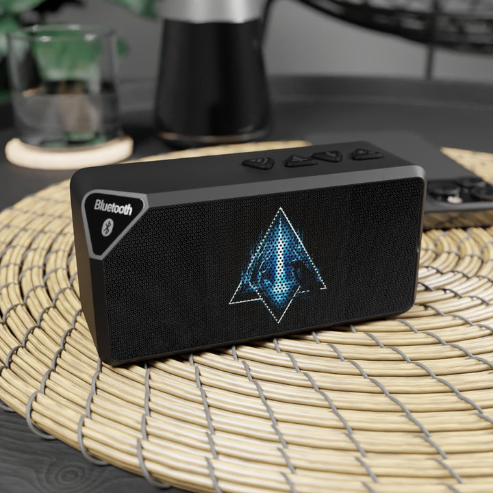 Sea Dragon Dreams portable Bluetooth speaker in matte black with an illuminated geometric emblem on the front grille.