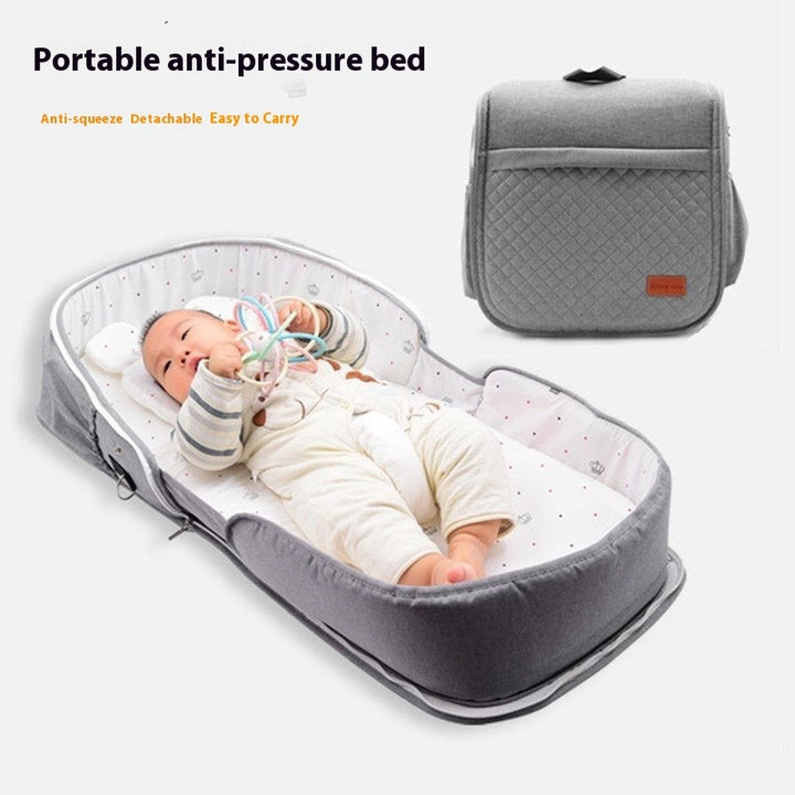 Sea Dragon Dreams portable grey quilted baby lounger with a newborn playing inside and a folded carrying case view