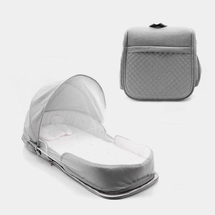 Sea Dragon Dreams grey portable baby lounger with a foldable canopy and quilted exterior for supervised lounging.
