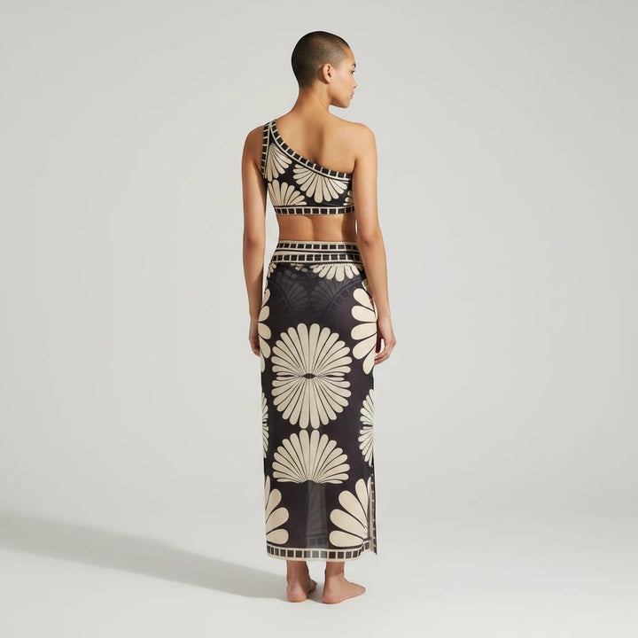 Sea Dragon Dreams one-shoulder bikini set with matching long cover-up skirt in a black and cream floral print