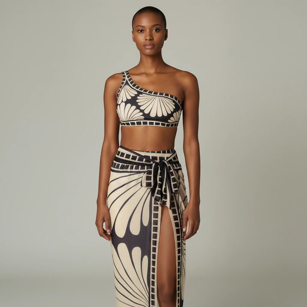 Sea Dragon Dreams one-shoulder bikini set with matching cover-up skirt in a black and cream shell-inspired print