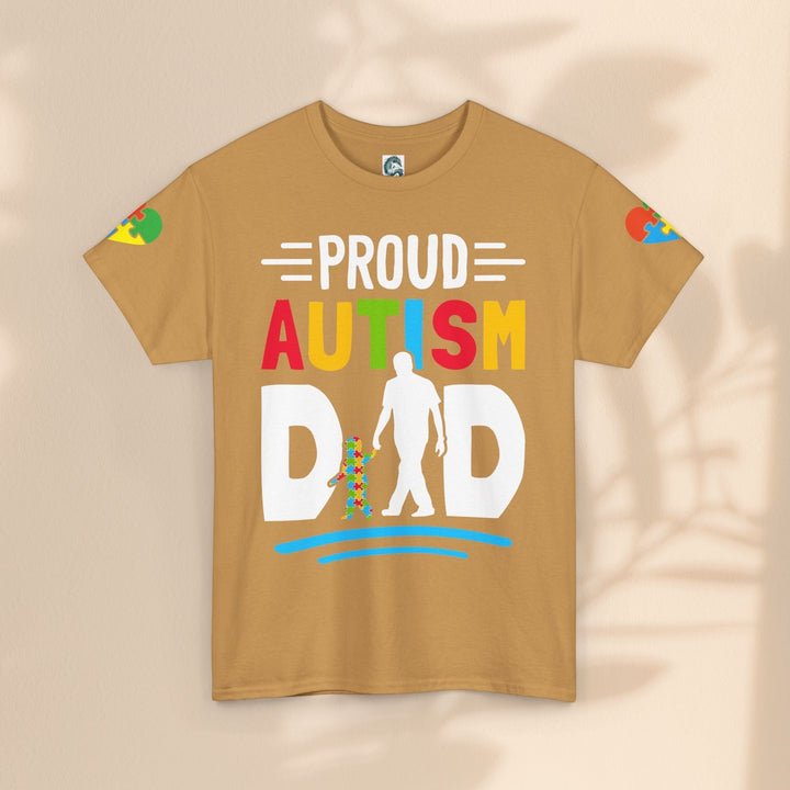 Sea Dragon Dreams Proud Autism Dad heavy cotton t-shirt in tan with a colorful graphic and puzzle piece accents.