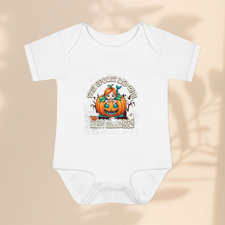 Sea Dragon Dreams infant bodysuit in white cotton with a Stay Spooky and Cute pumpkin Halloween graphic print.