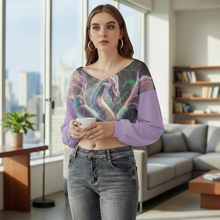 Sea Dragon Dreams purple V-neck long sleeve cropped sweatshirt with dragon graphic print worn by a woman