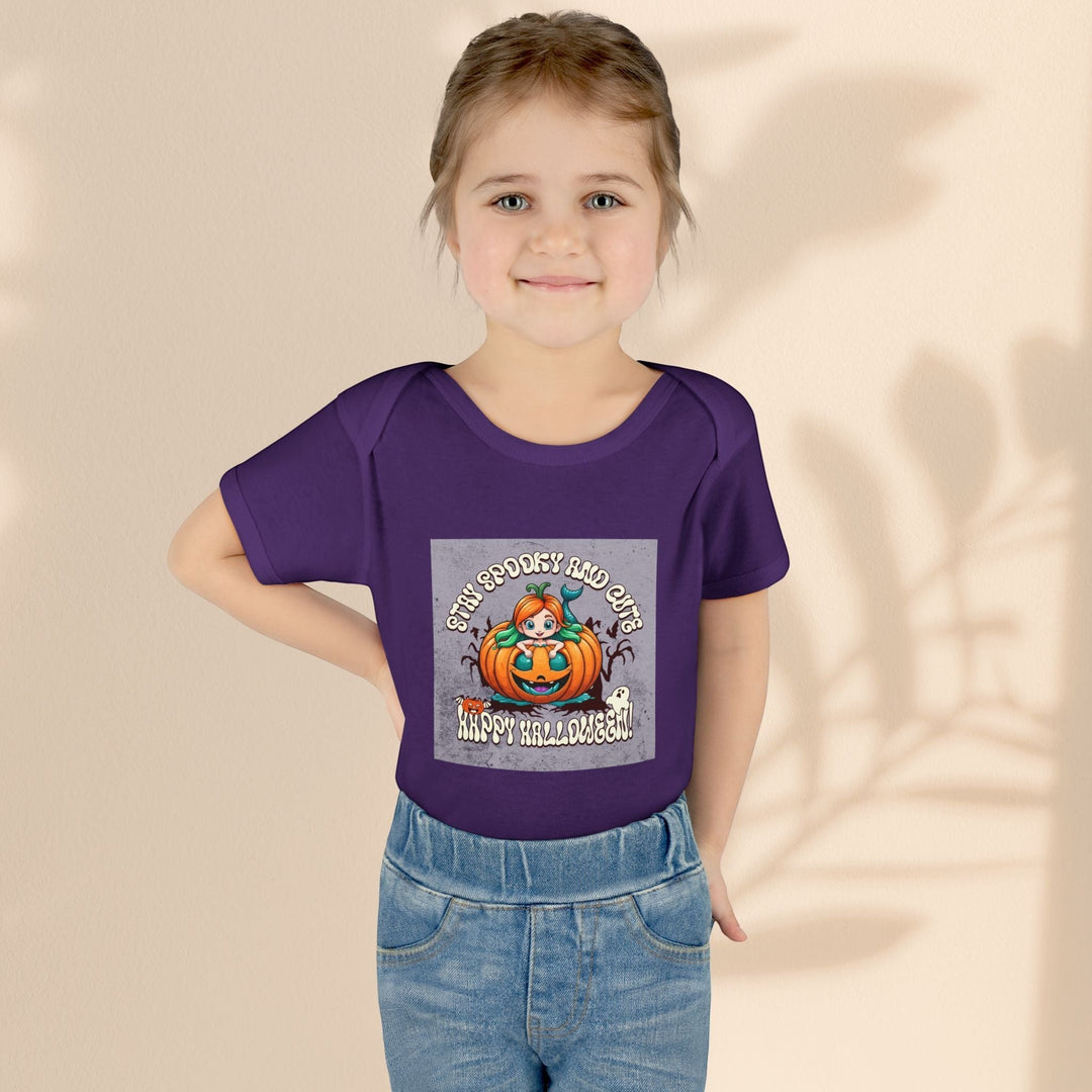 Sea Dragon Dreams infant bodysuit in purple with Stay Spooky and Cute pumpkin Halloween graphic on a young child.