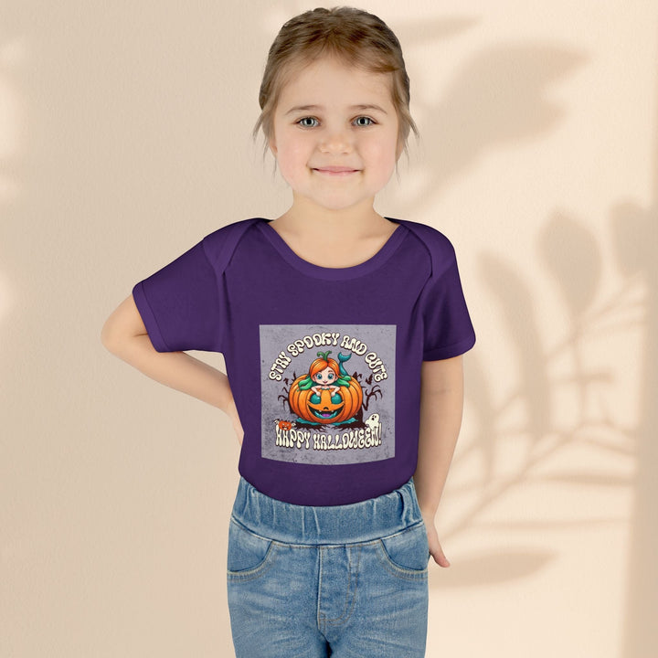 Sea Dragon Dreams infant bodysuit in purple with Stay Spooky and Cute pumpkin Halloween graphic on a young child.
