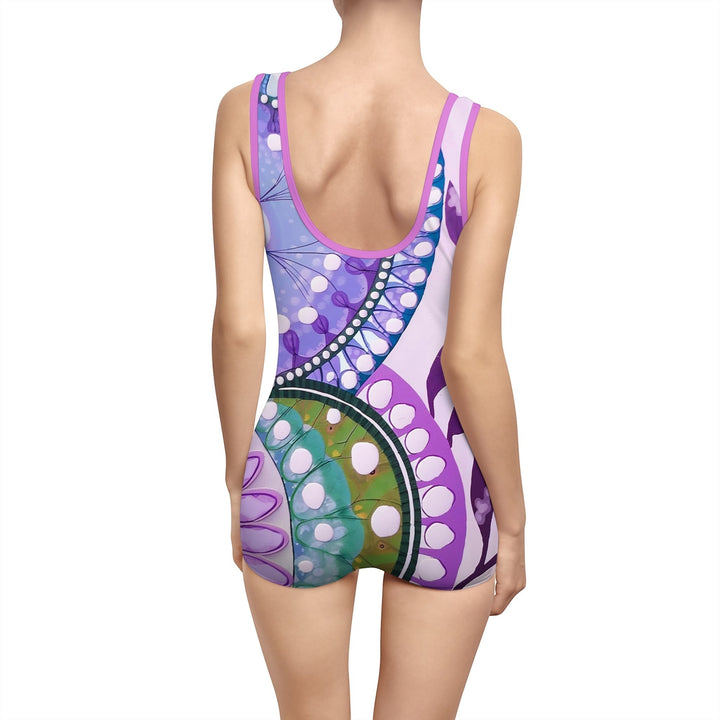 Sea Dragon Dreams purple one-piece swimsuit with a vibrant abstract pattern, scoop neck, and low back design.