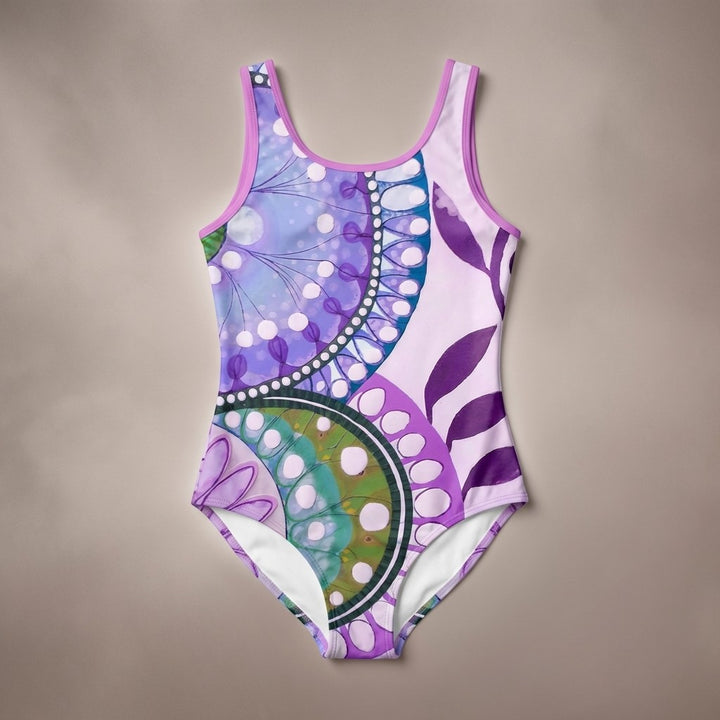 Sea Dragon Dreams Purple Delight one-piece swimsuit with a vibrant purple and green circular mandala-style print.