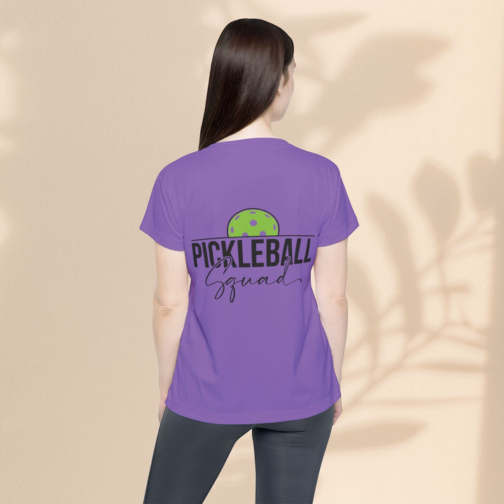 Sea Dragon Dreams purple moisture-wicking sports jersey with Pickleball Squad graphic worn by a woman from the back.