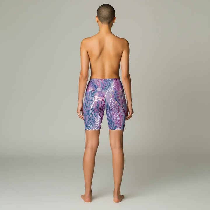 Sea Dragon Dreams purple seaweed print workout shorts on a model, back view showing polyester fabric and fit.