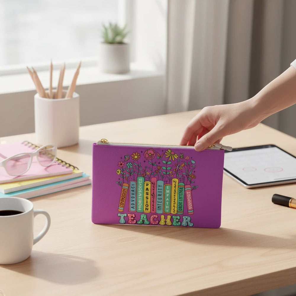 Sea Dragon Dreams purple faux leather clutch bag with a colorful teacher appreciation design on a desk.