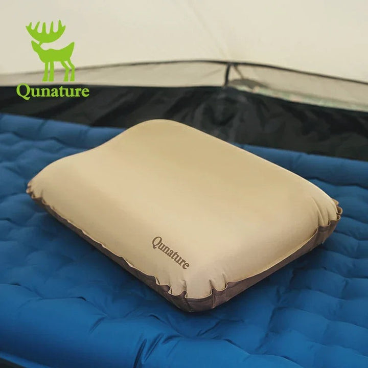Sea Dragon Dreams Qunature self-inflating camping pillow in beige with 3D high-elastic sponge support on a blue mat.