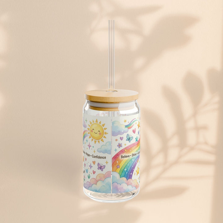 Sea Dragon Dreams 16oz clear glass sipper with bamboo lid, straw, and colorful rainbow, sun, and cloud illustration.