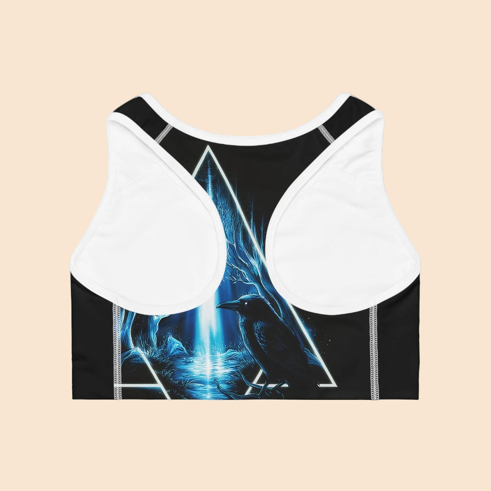 Sea Dragon Dreams Message of Revolution racerback sports bra featuring a blue raven and forest triangle graphic print