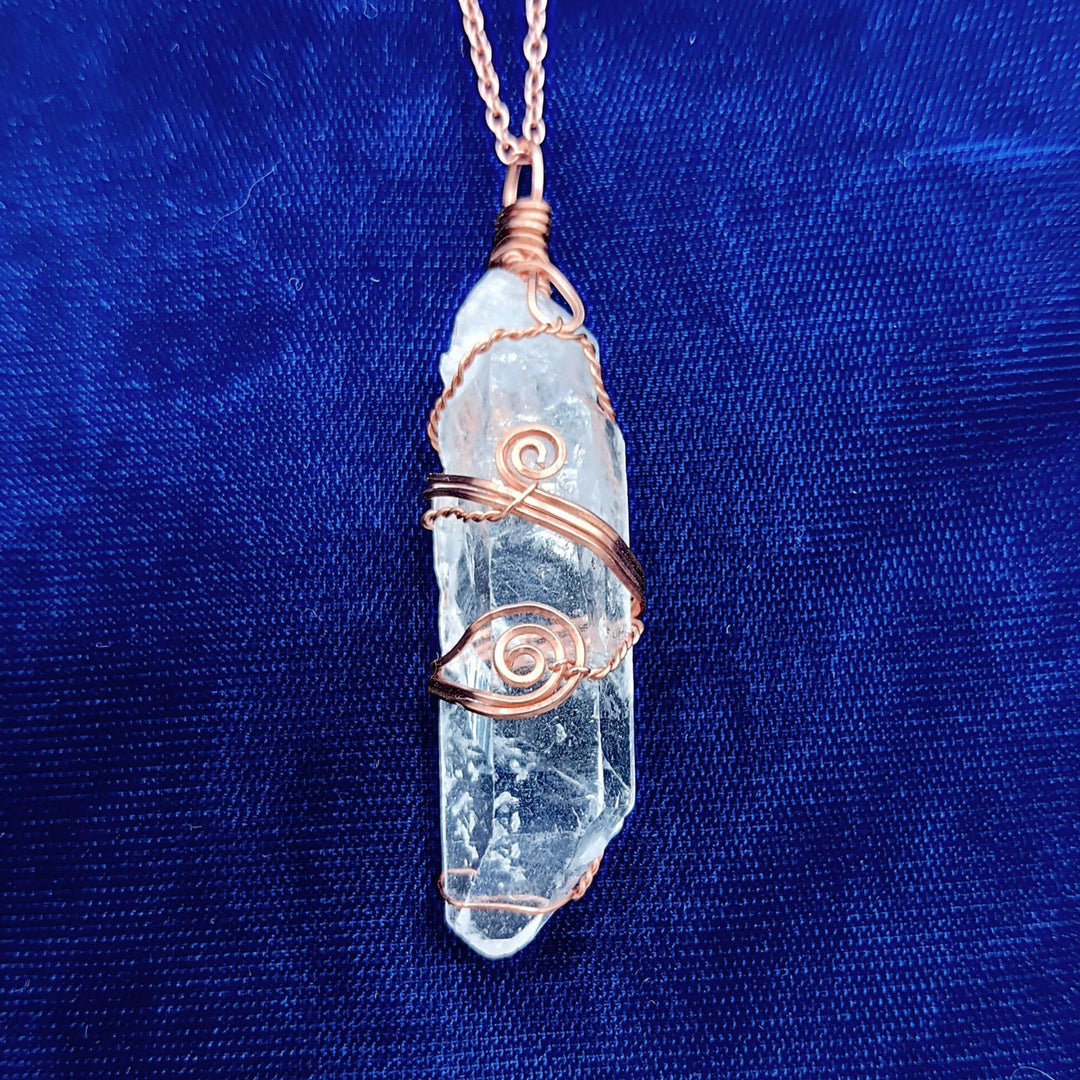 Sea Dragon Dreams raw clear quartz crystal point pendant with artisan hand-wrapped copper wire on a matching chain.