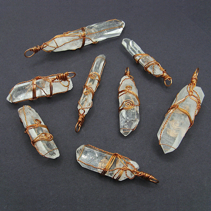Sea Dragon Dreams collection of handmade raw clear quartz crystal pendants wrapped in rustic solid copper wire