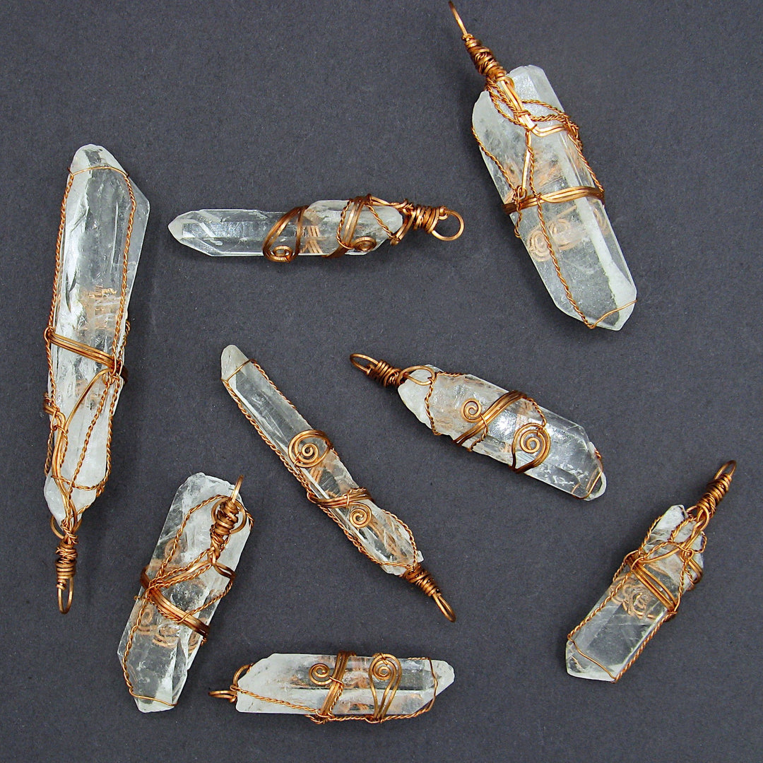 Sea Dragon Dreams collection of raw clear quartz crystal pendants, each uniquely hand-wrapped in rustic copper wire.
