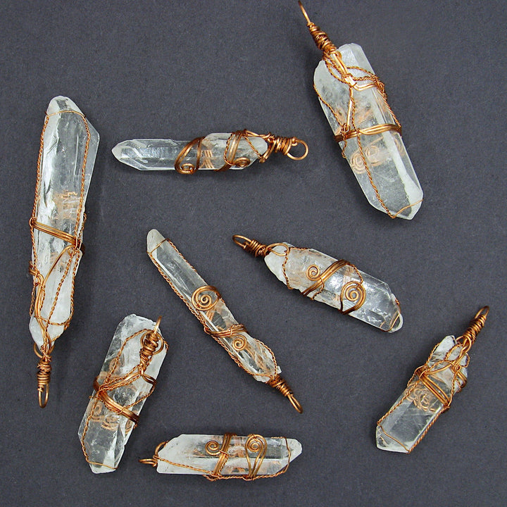 Sea Dragon Dreams collection of raw clear quartz crystal pendants, each uniquely hand-wrapped in rustic copper wire.