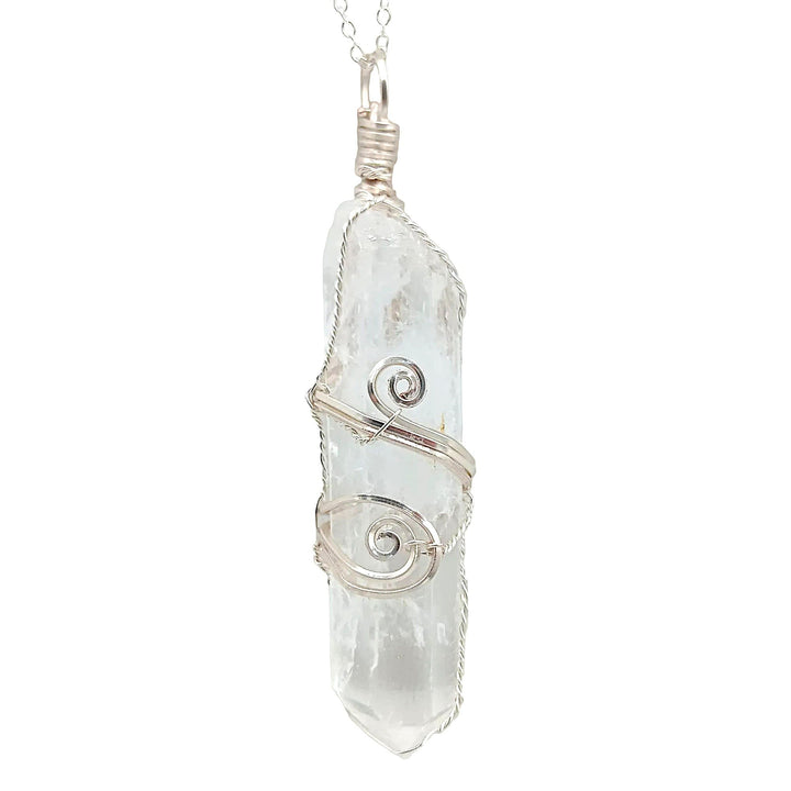 Sea Dragon Dreams raw clear quartz crystal pendant with intricate silver-plated wire wrapping on a delicate chain.