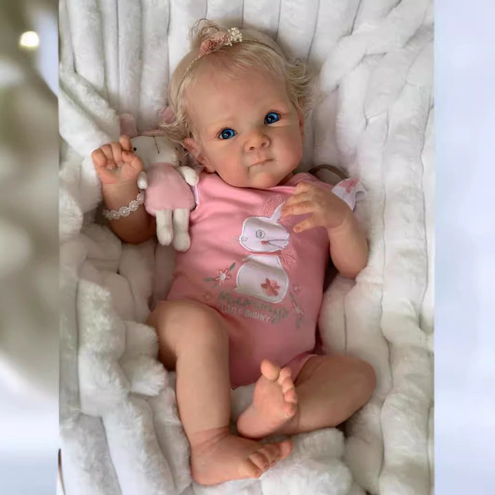 Sea Dragon Dreams 18-inch lifelike reborn baby doll with blonde hair, blue eyes, and a pink bunny-themed outfit