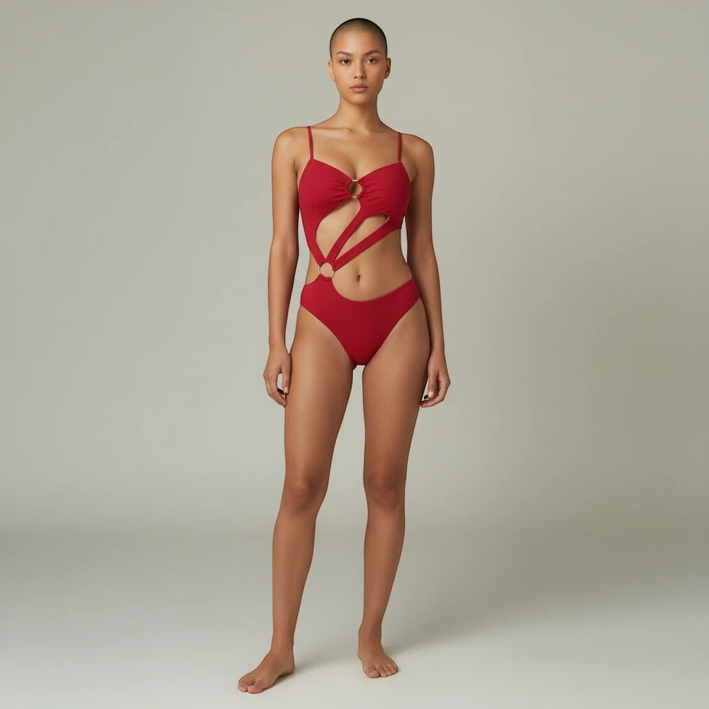 Sea Dragon Dreams red cut-out one-piece swimsuit with double-strap detail and ring accents on a model