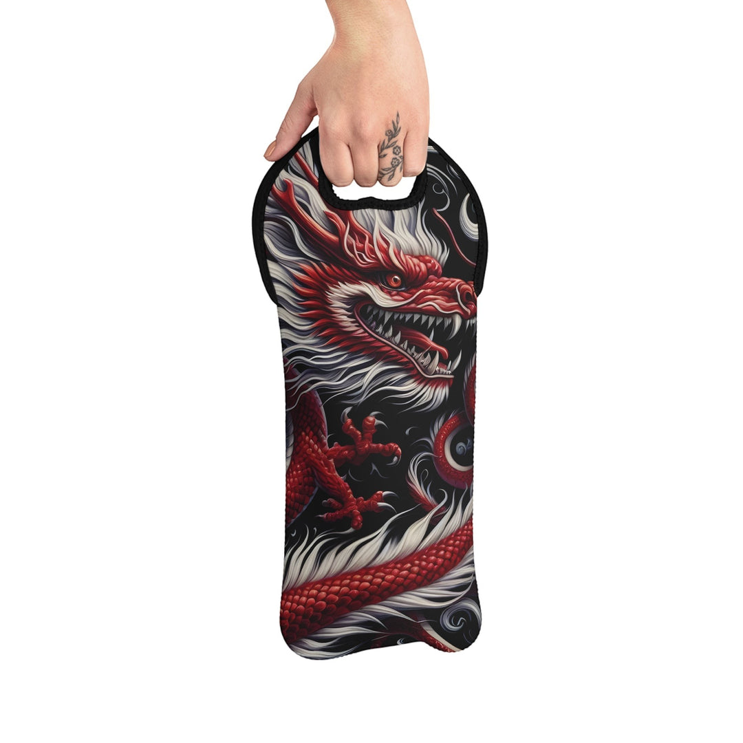 Sea Dragon Dreams neoprene wine tote with a bold red dragon print and black trim, held by a hand.