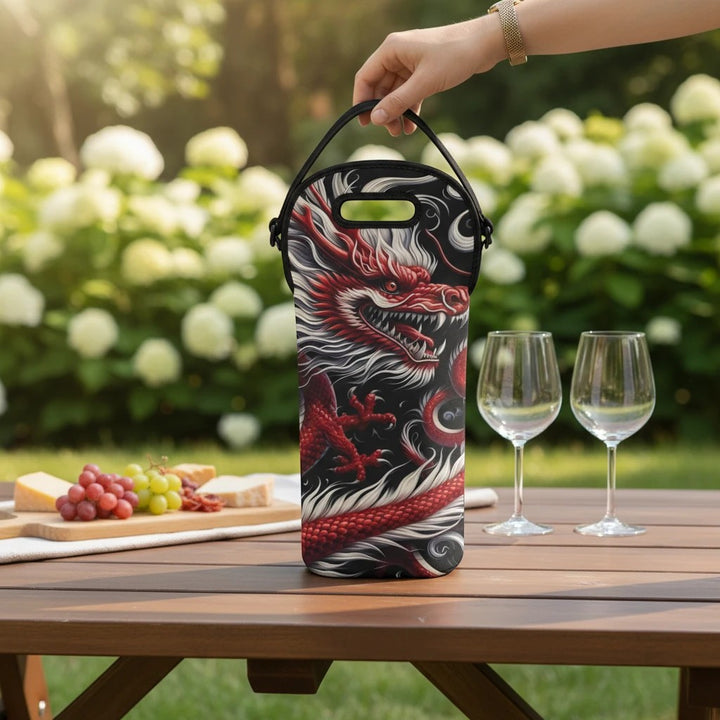 Sea Dragon Dreams neoprene wine tote featuring a bold red dragon print on a black background, held on a garden table.