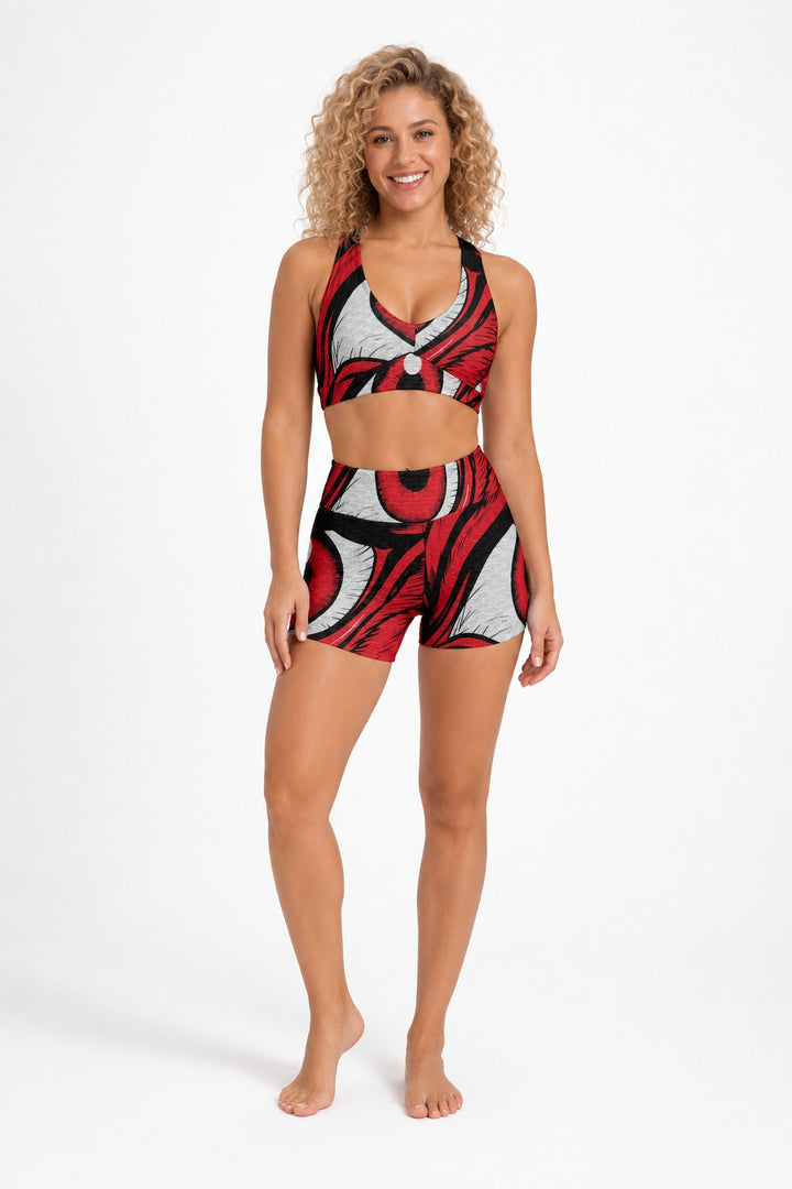 Sea Dragon Dreams women's sports bra and high-waisted shorts set featuring a bold red and black eye-inspired print.