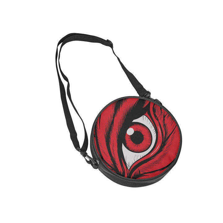 Sea Dragon Dreams round canvas satchel bag featuring a dramatic red eye graphic and adjustable black shoulder strap.