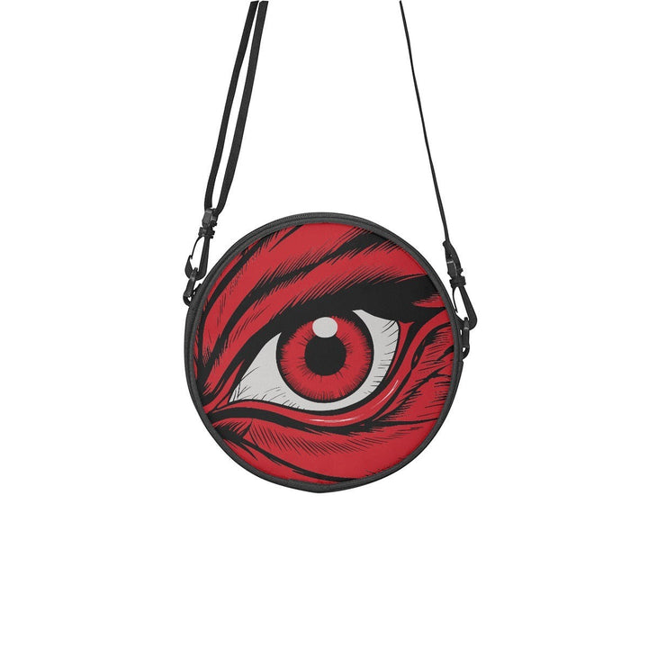 Sea Dragon Dreams round canvas satchel bag featuring a dramatic red eye graphic and adjustable black shoulder strap.