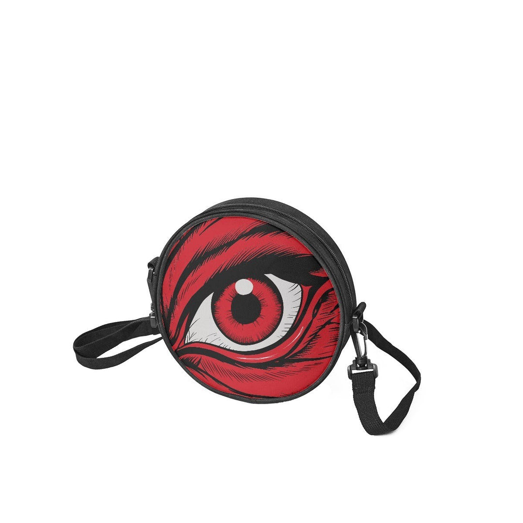 Sea Dragon Dreams round canvas satchel bag featuring a dramatic red eye graphic design and black shoulder strap.