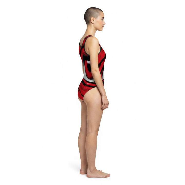 Side view of a model wearing a Sea Dragon Dreams one-piece swimsuit with a bold red eye graphic print