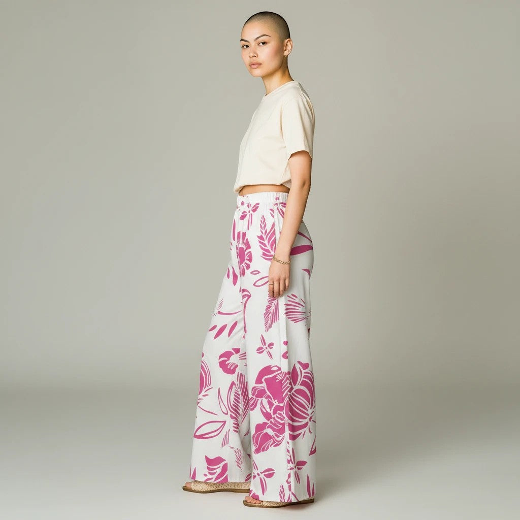 Sea Dragon Dreams women's wide-leg pants featuring a vibrant red floral print on white lightweight polyester fabric.
