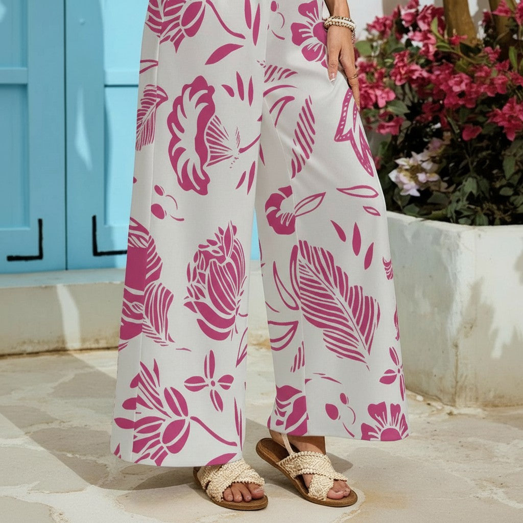Sea Dragon Dreams wide-leg pants in white with a vibrant red floral print, featuring a relaxed fit and side pockets.