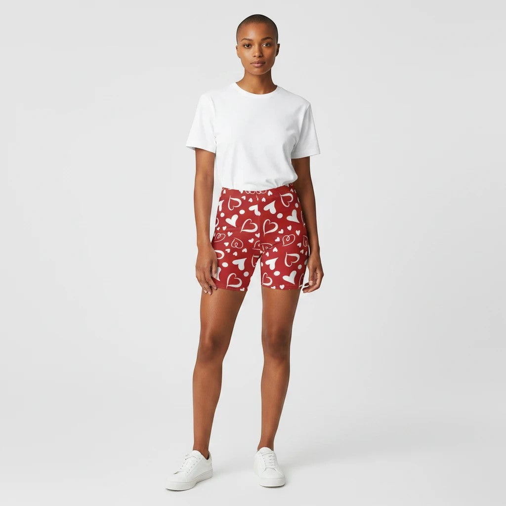 Sea Dragon Dreams high-waisted red biker shorts with white heart pattern worn by a model with a white t-shirt.