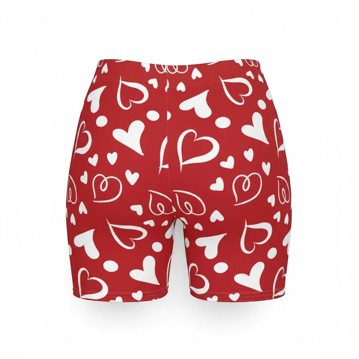 Sea Dragon Dreams high-waisted biker shorts in red with a white heart pattern, made from moisture-wicking fabric.