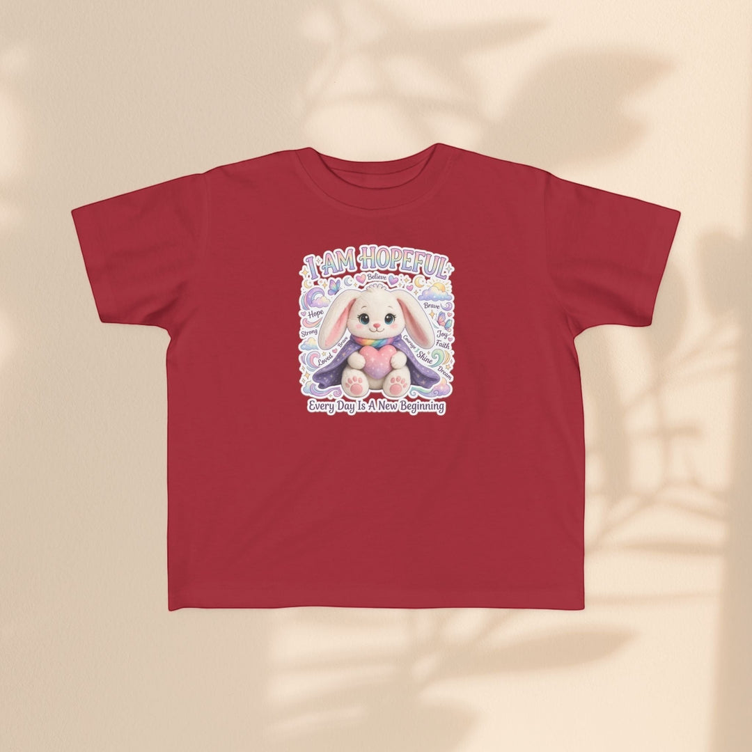 Sea Dragon Dreams red toddler tee featuring a cute Hope Bunny graphic with the text I Am Hopeful and soft motifs.