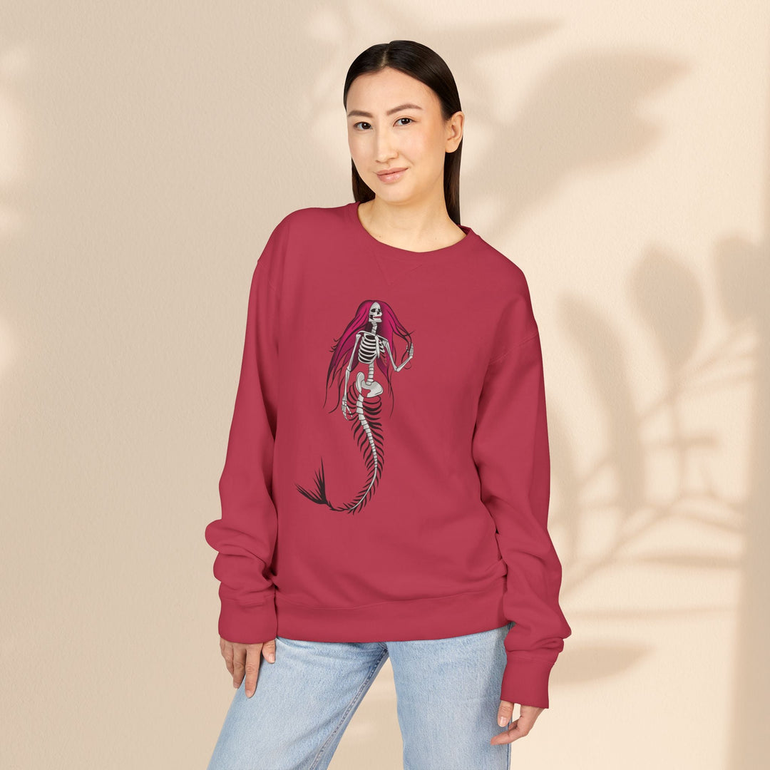 Model wearing a Sea Dragon Dreams red crewneck sweatshirt featuring a gothic skeletal mermaid graphic.