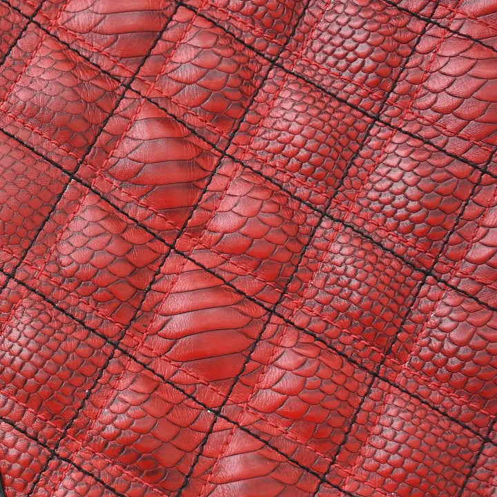 Sea Dragon Dreams red diamond-quilted leather texture with a detailed snakeskin pattern on a motorcycle jacket.