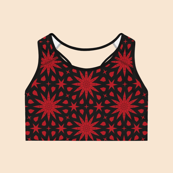 Sea Dragon Dreams seamless sports bra in black with a vivid red geometric star pattern and racerback design.