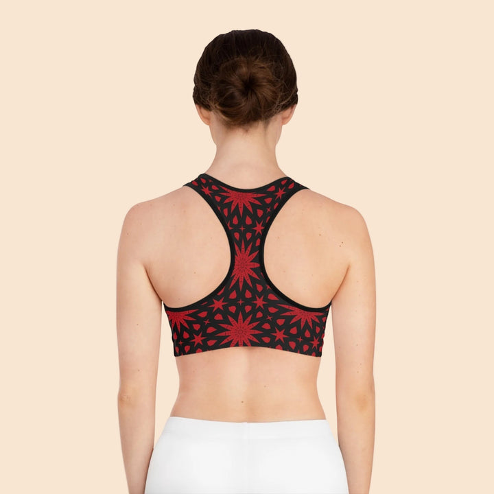 Sea Dragon Dreams seamless sports bra with a red star pattern on black fabric, featuring a racerback design.