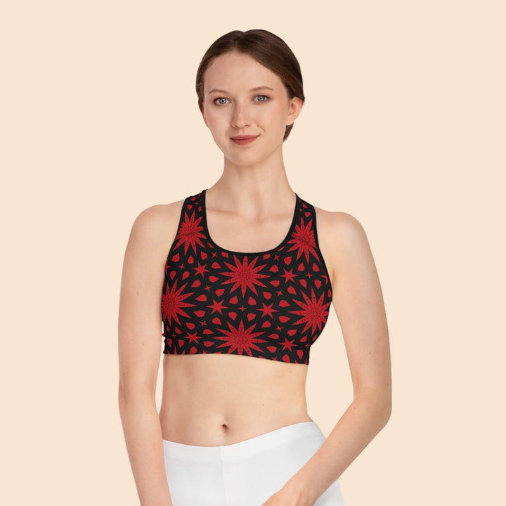 Sea Dragon Dreams seamless sports bra with a bold red star pattern on black fabric, featuring a racerback design.