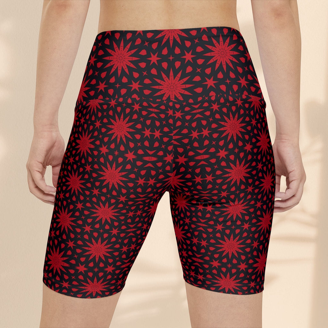 Sea Dragon Dreams red spiral star print workout shorts on a person, back view showing athletic fit and pattern.