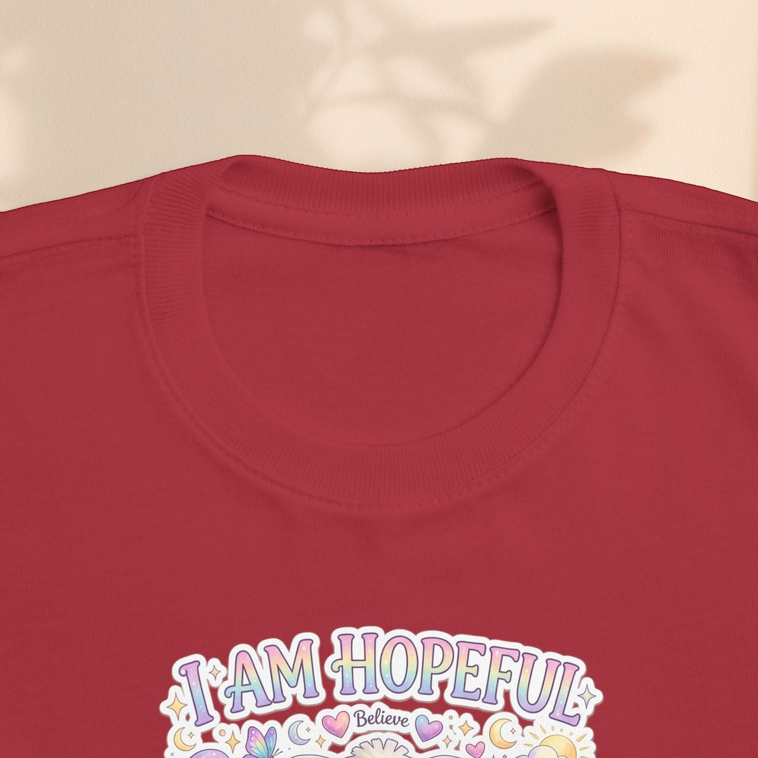 Sea Dragon Dreams toddler tee in red cotton with I Am Hopeful graphic featuring Hope Bunny and pastel accents.
