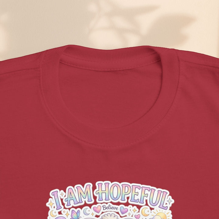 Sea Dragon Dreams toddler tee in red cotton with I Am Hopeful graphic featuring Hope Bunny and pastel accents.