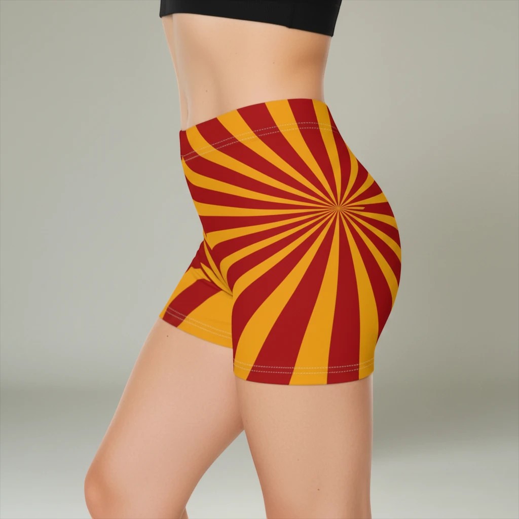Sea Dragon Dreams women's skinny fit shorts in a vibrant red and yellow sunburst pattern with a faux suede finish.