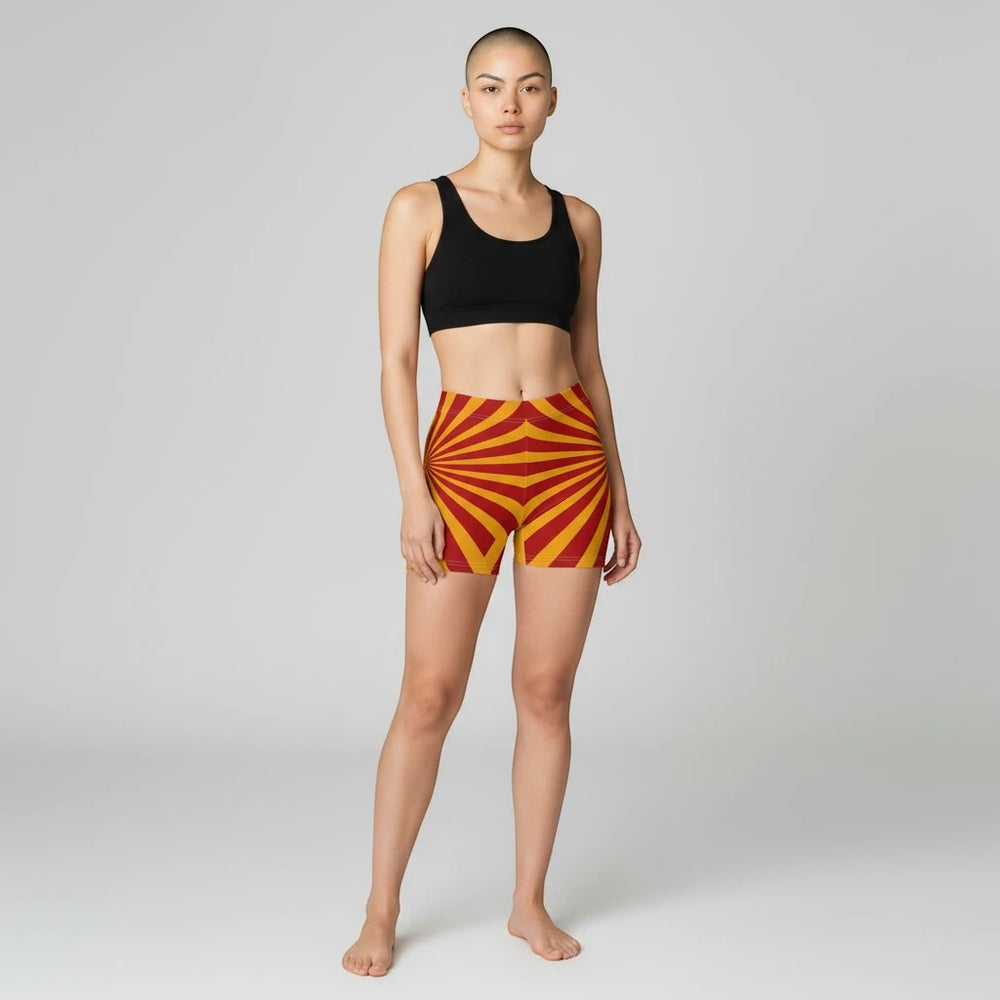 Sea Dragon Dreams women's skinny fit shorts in red and yellow sunburst pattern, made from moisture-wicking fabric.
