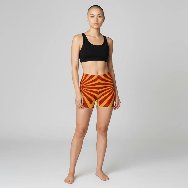 Sea Dragon Dreams women's skinny fit shorts in red and yellow sunburst pattern, made from moisture-wicking fabric.