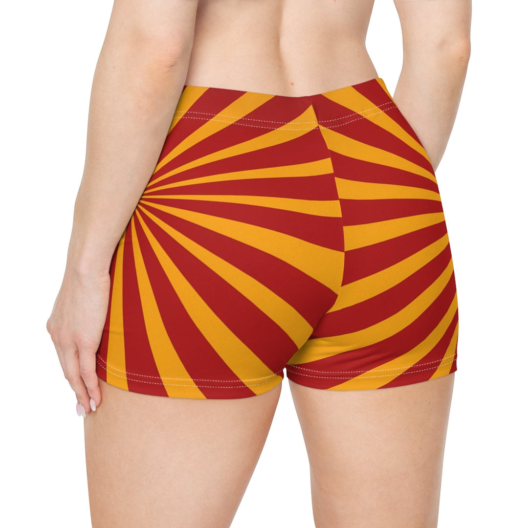 Sea Dragon Dreams women's skinny fit shorts in a vibrant red and yellow sunburst pattern with a faux suede finish.